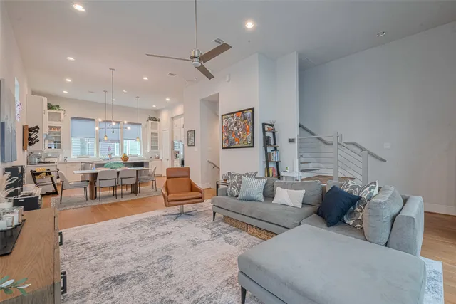 a living room with furniture and wooden floor