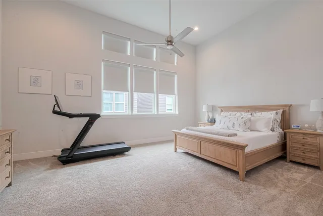 a spacious bedroom with a bed and a window