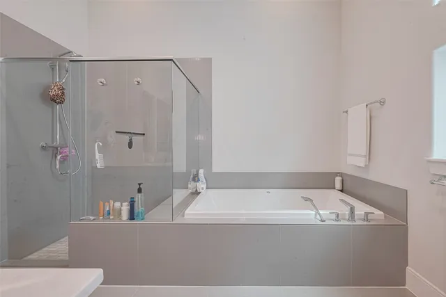a view of a bathroom with a tub and mirror