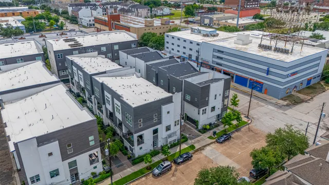 an aerial view of a house with pool and trees