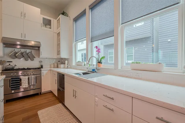 a kitchen with a sink stove and cabinets