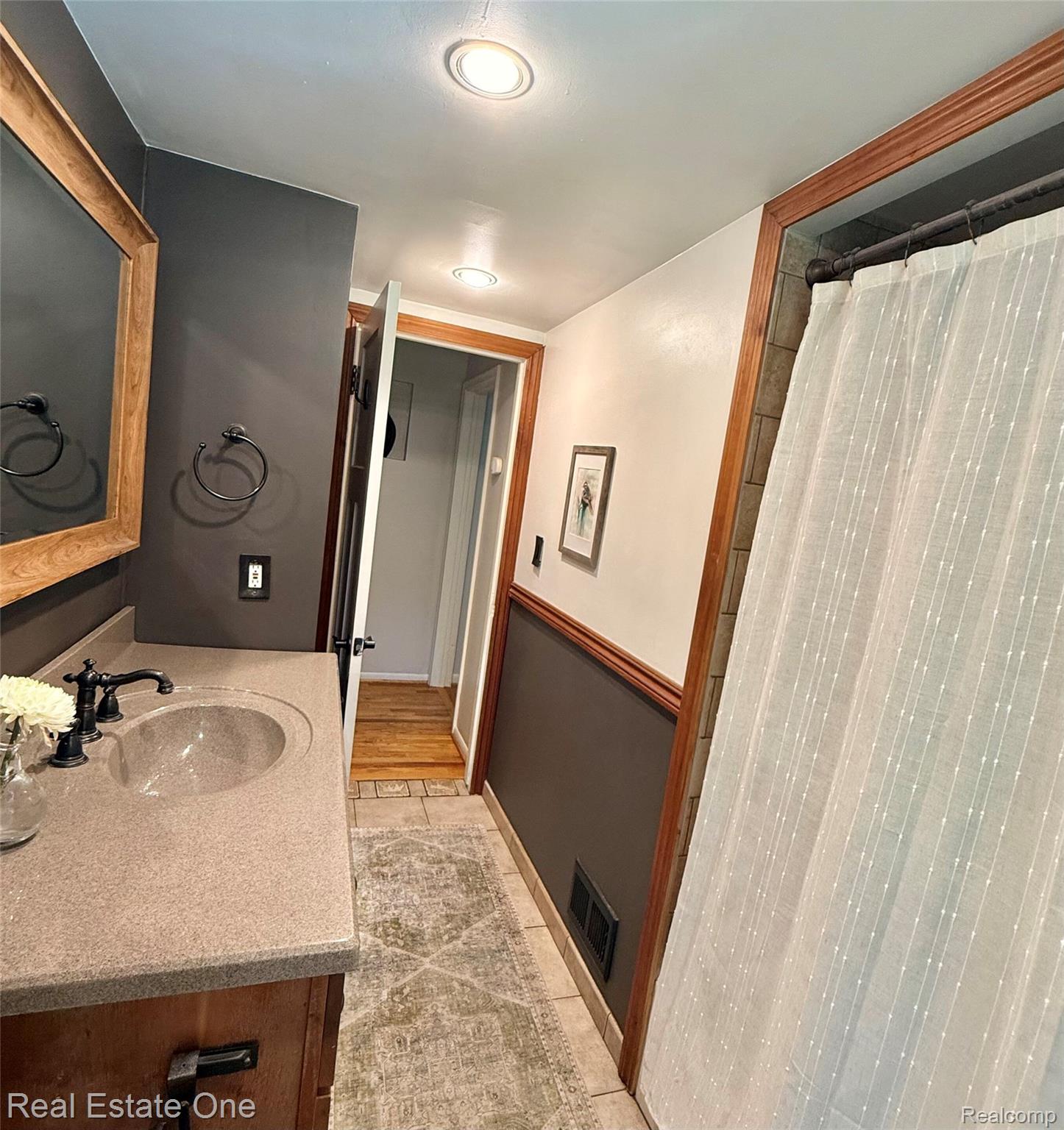 2189 Devonshire Road Bloomfield Hills, MI 48302 - Photo 20 of 50 Bathroom featuring a wood-finish vanity with an integrated sink and oil-rubbed bronze fixtures