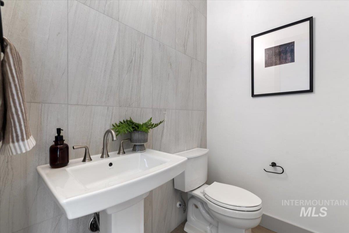 7580 West Old School Street, Unit FREMONT Meridian, ID 83646 - Photo 12 of 28 Bathroom featuring tile walls and toilet
