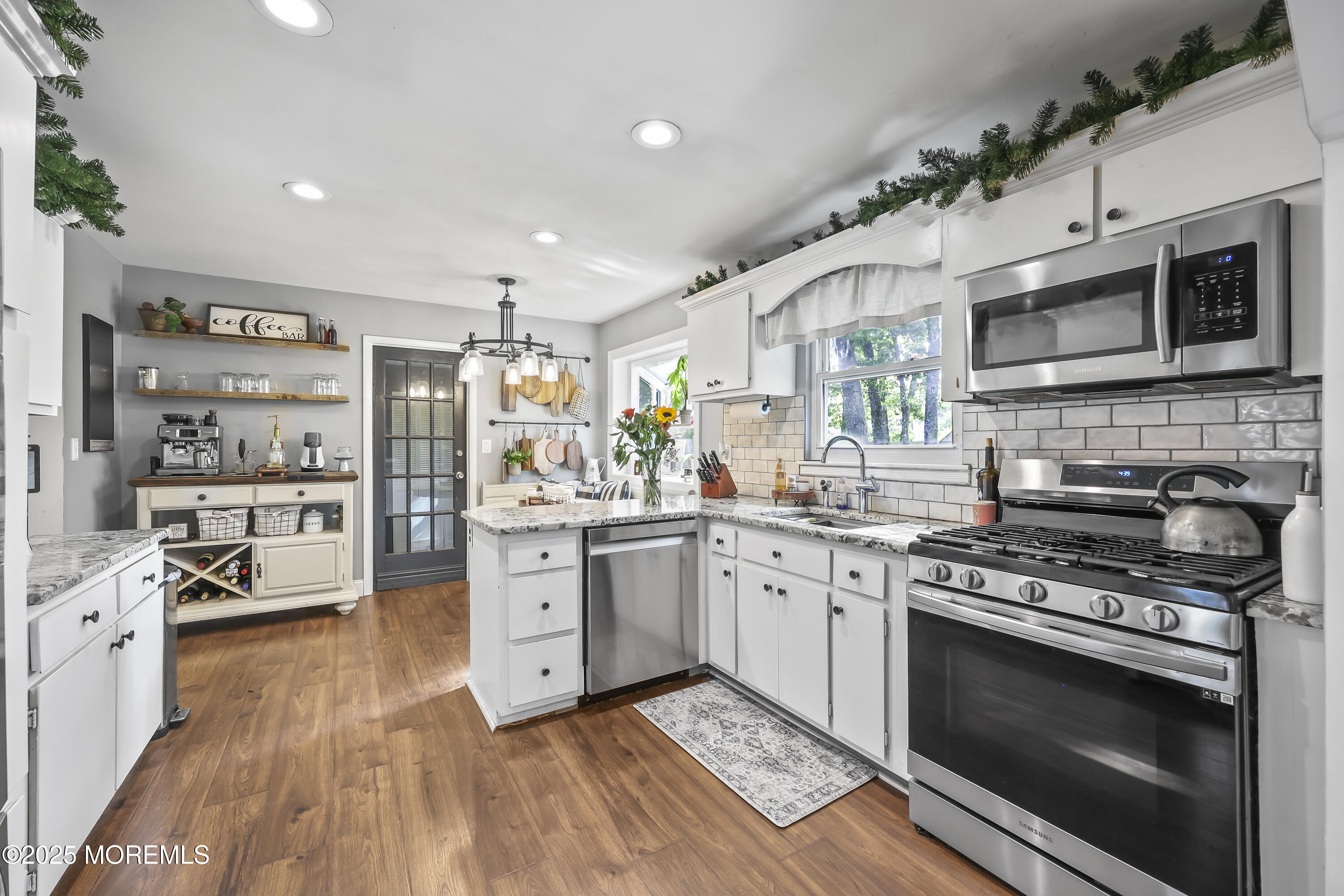 91 Newbury Road Howell, NJ 07731 - Photo 14 of 34 a kitchen with stainless steel appliances granite countertop a stove and cabinets