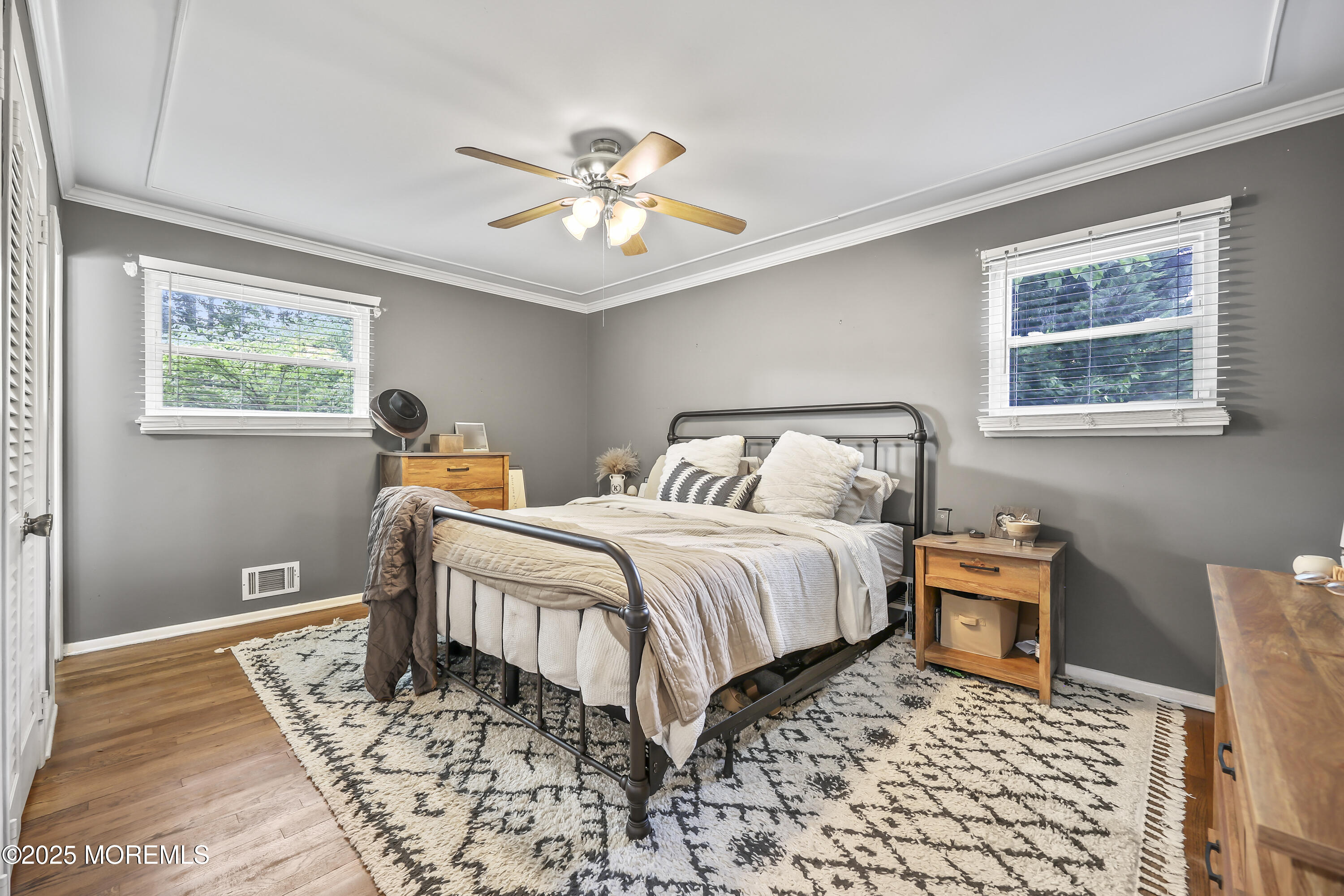 91 Newbury Road Howell, NJ 07731 - Photo 23 of 34 a bedroom with a bed and a chandelier