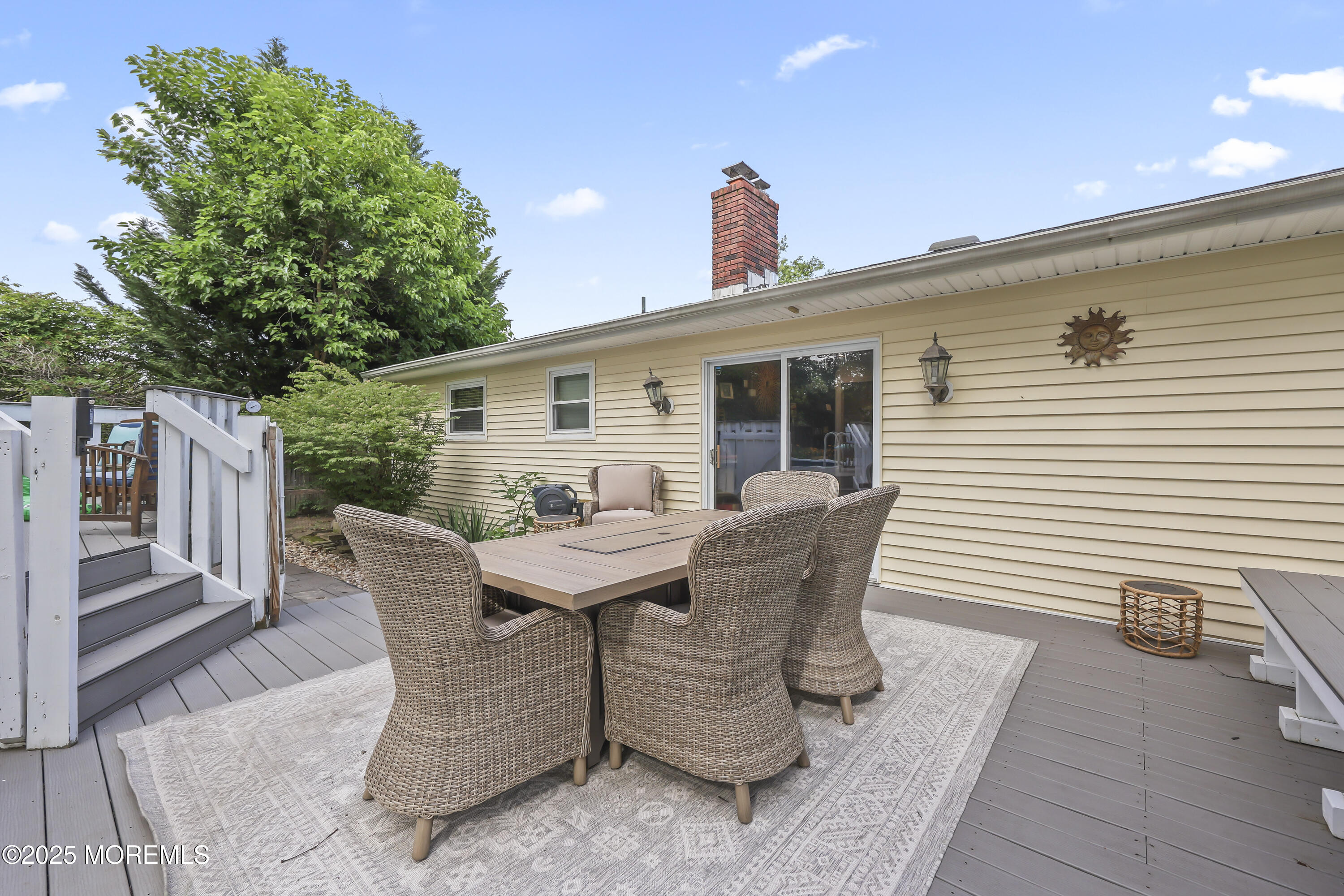 91 Newbury Road Howell, NJ 07731 - Photo 29 of 34 a view of a patio with table and chairs and wooden floor