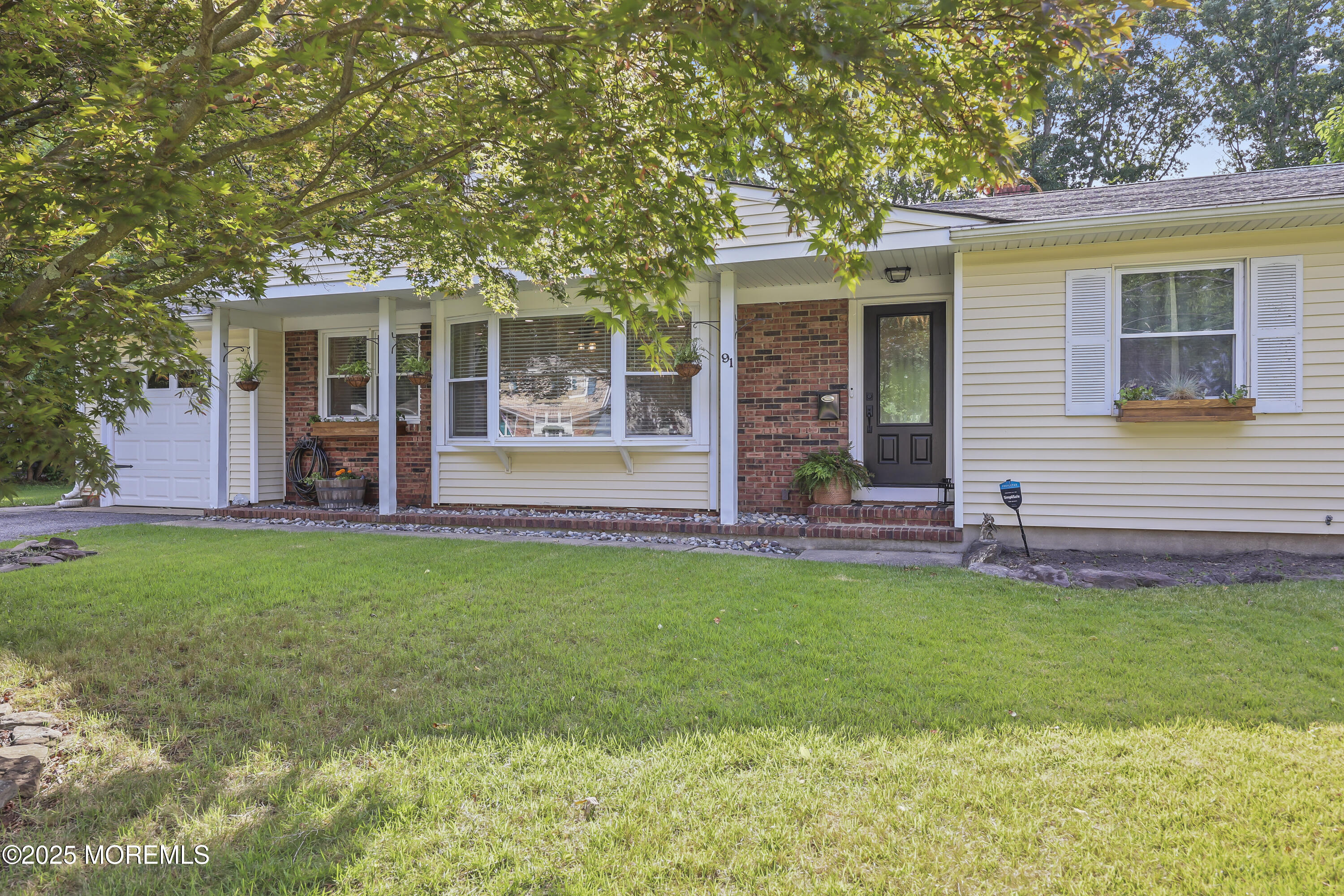 91 Newbury Road Howell, NJ 07731 - Photo 3 of 34 a front view of a house with a garden
