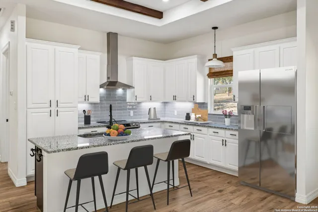 a kitchen with stainless steel appliances granite countertop a sink stove and refrigerator