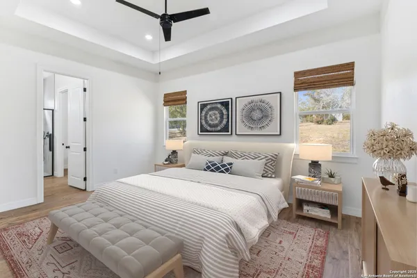 a bedroom with a large bed and a chandelier