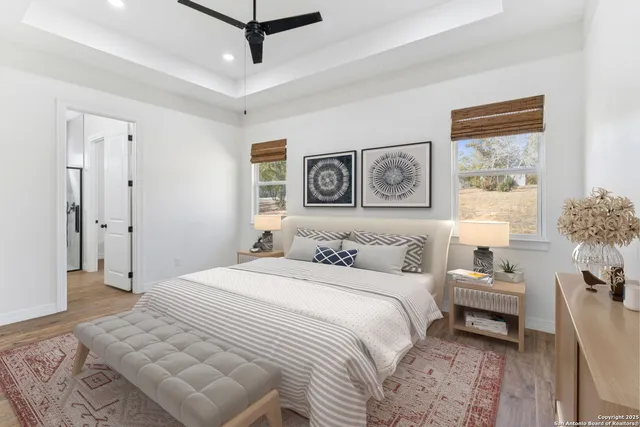 a bedroom with a large bed and a chandelier