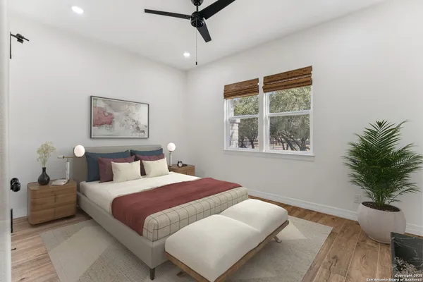 a bedroom with a large bed and a window
