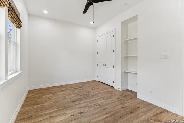 wooden floor in an empty room with a window