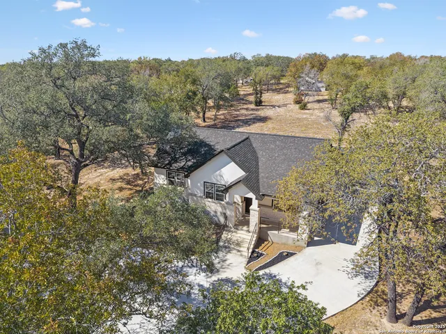 an aerial view of residential houses with outdoor space