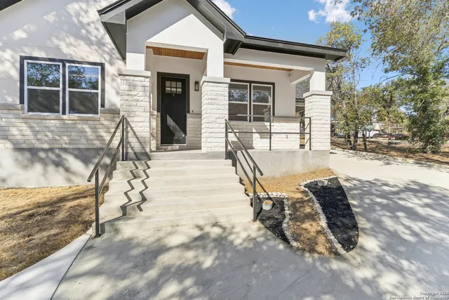 a view of a house with backyard porch and sitting area
