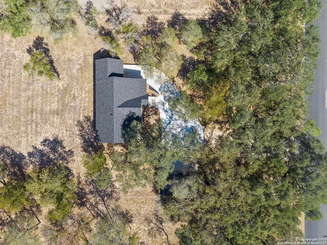 an aerial view of a house with a yard