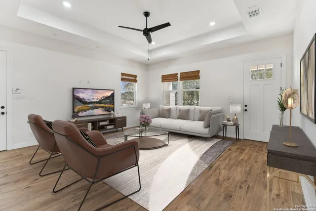 a living room with furniture a ceiling fan and a rug