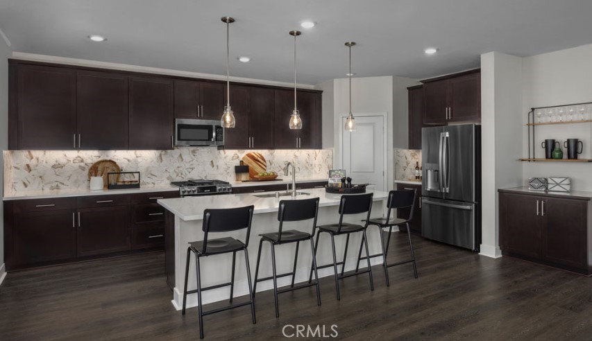 33425 Rusty Court French Valley, CA 92596 - Photo 5 of 25 a kitchen with kitchen island granite countertop a sink cabinets and stainless steel appliances
