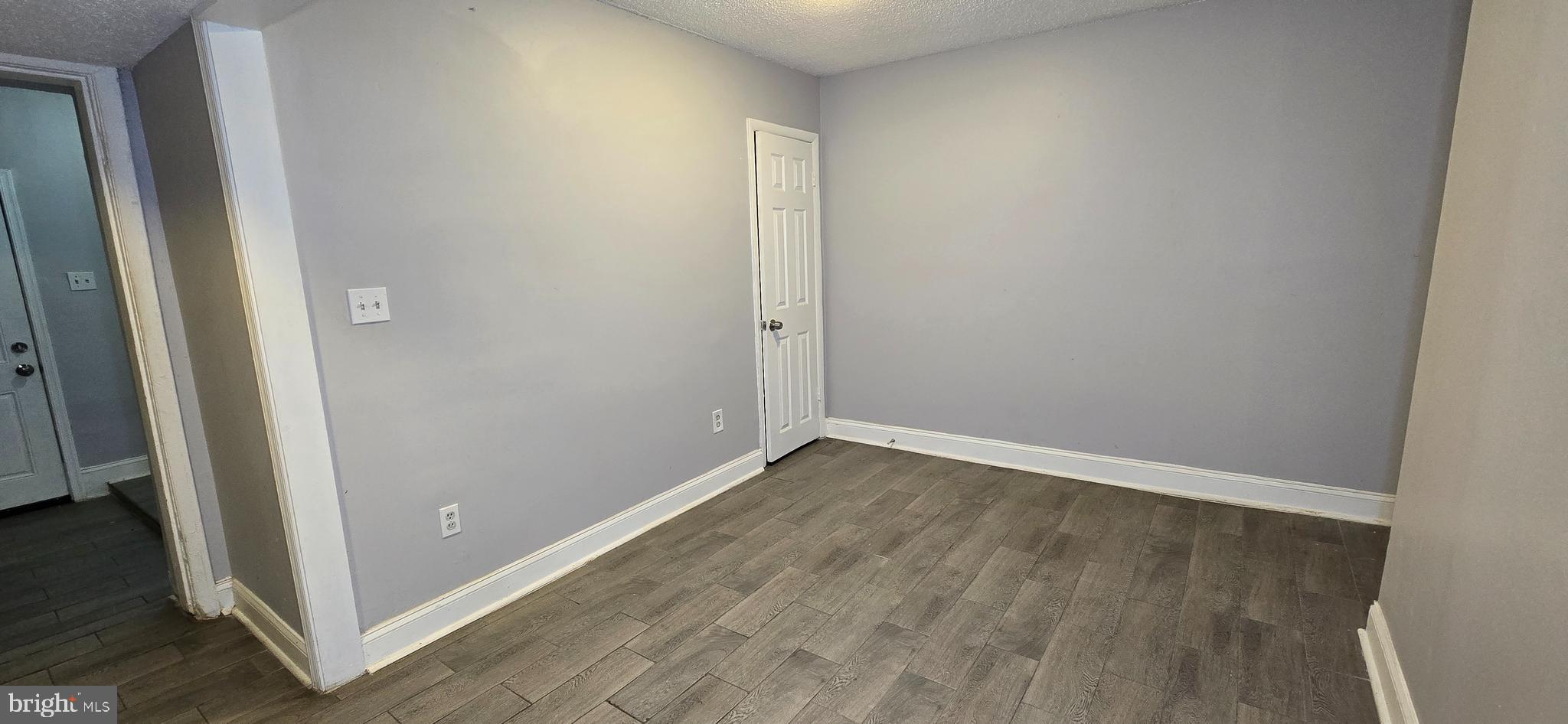 1702 Gales Street Northeast, Unit 3 Washington, DC 20002 - Photo 8 of 13 an empty room with wooden floor and entrance