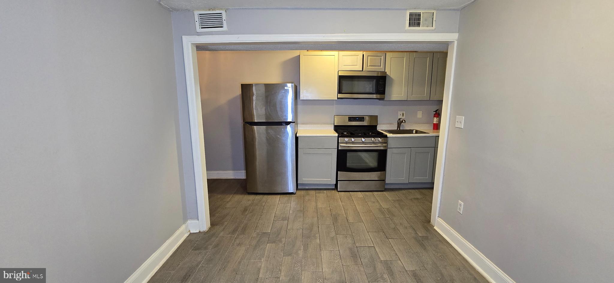 1702 Gales Street Northeast, Unit 3 Washington, DC 20002 - Photo 9 of 13 a kitchen with a refrigerator and a stove top oven