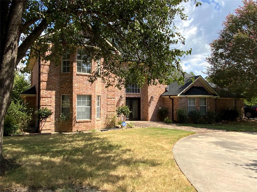 2020 Arbor Bend Road Bonham, TX 75418 - Photo 1 of 30 Brick exterior with multiple windows, a distinct roofline, and a paved driveway