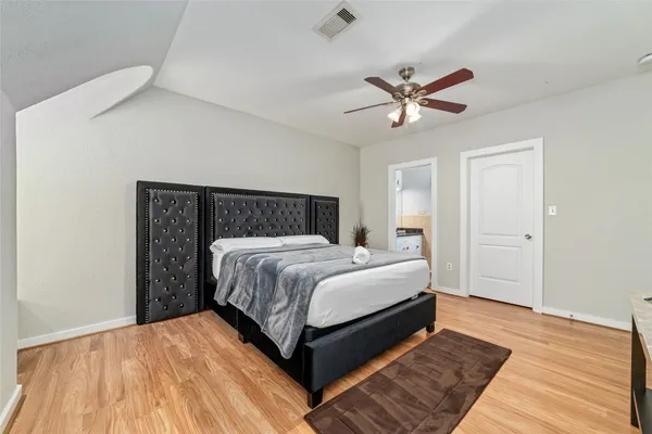 a bedroom with a bed and window