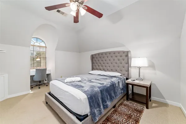 a bedroom with bed and a window