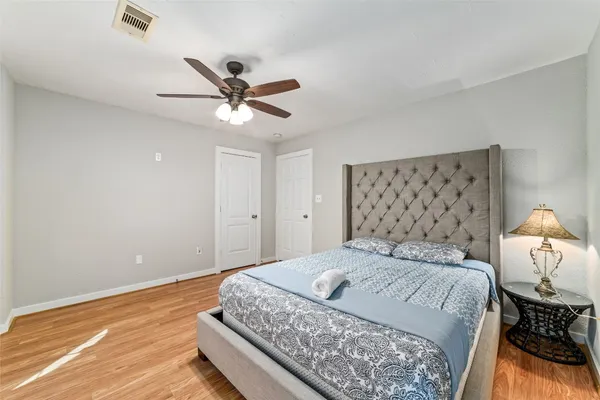 a bedroom with a bed and a ceiling fan