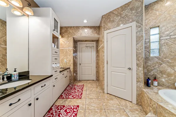 a bathroom with a mirror and a shower