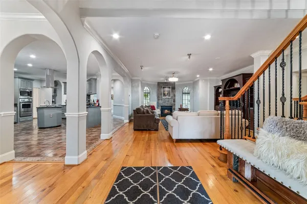 a view of a dining room with furniture a chandelier and wooden floor