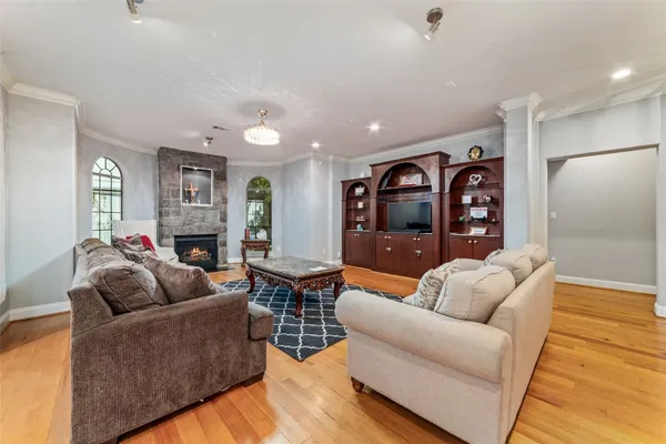 a living room with furniture a dining table and wooden floor