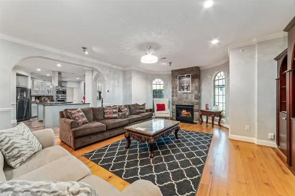 a living room with furniture and a chandelier
