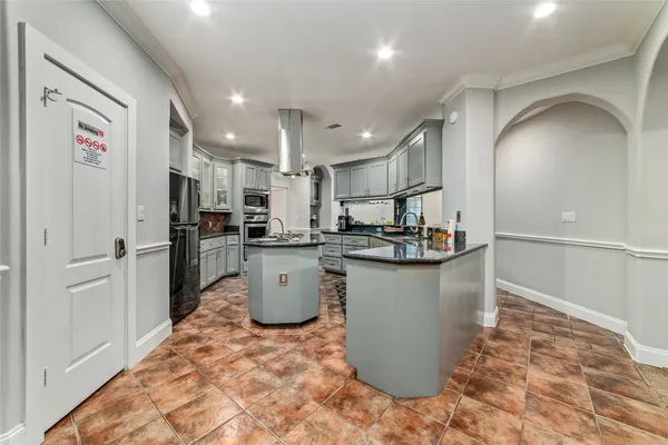 a kitchen with stainless steel appliances granite countertop a refrigerator and a sink