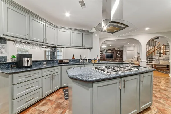 a kitchen with stainless steel appliances granite countertop a sink refrigerator and cabinets