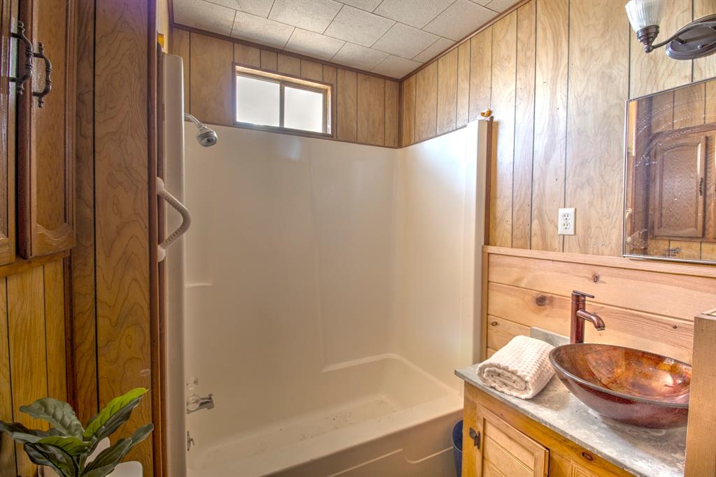 3356 Old Dorchester Road Sherman, TX 75092 - Photo 19 of 22 a bathroom with a sink and a mirror