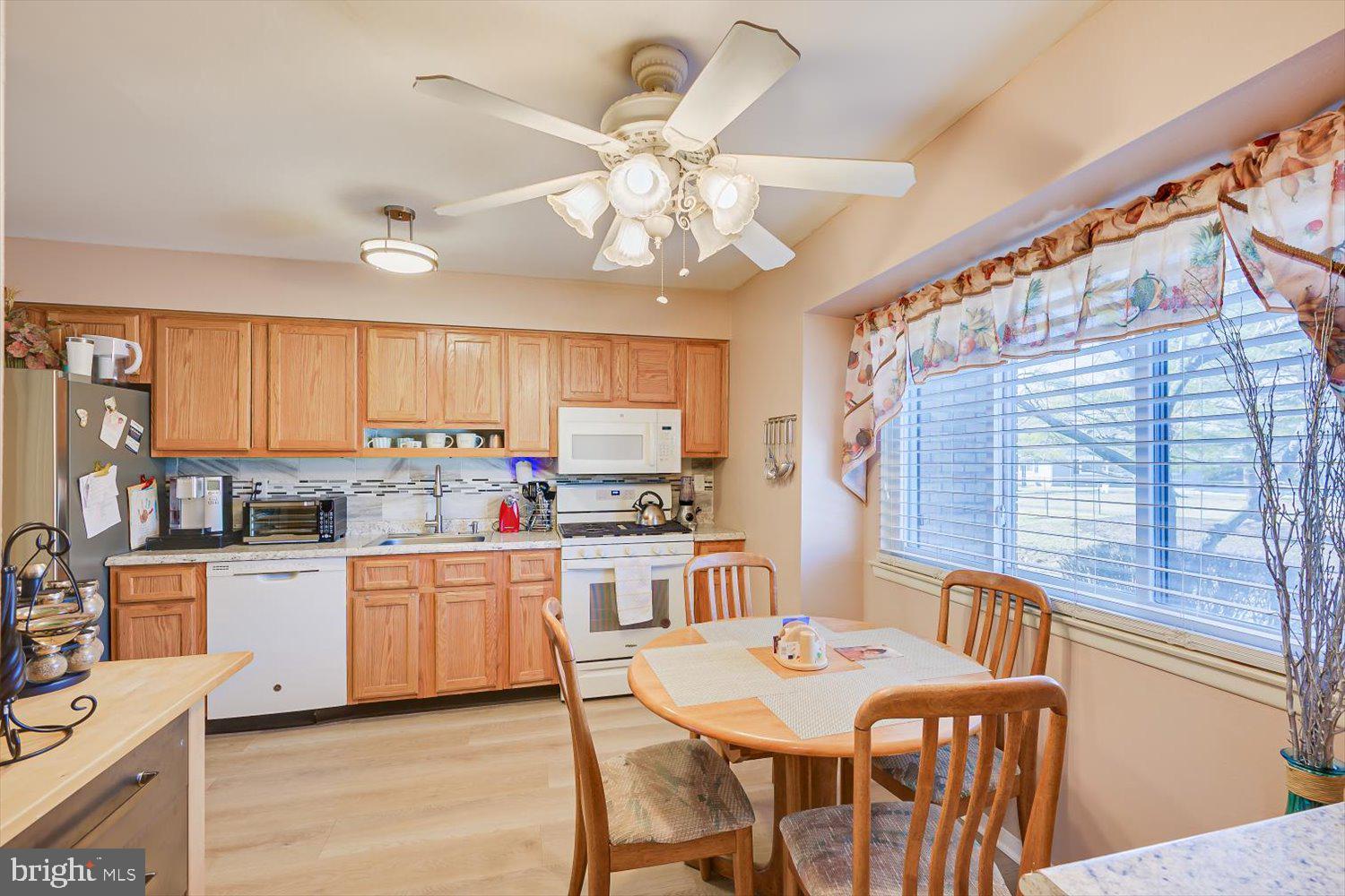 806 Robin Road Hillsborough, NJ 08844 - Photo 11 of 37 a kitchen with stainless steel appliances kitchen island granite countertop a stove top oven a sink a dining table and chairs