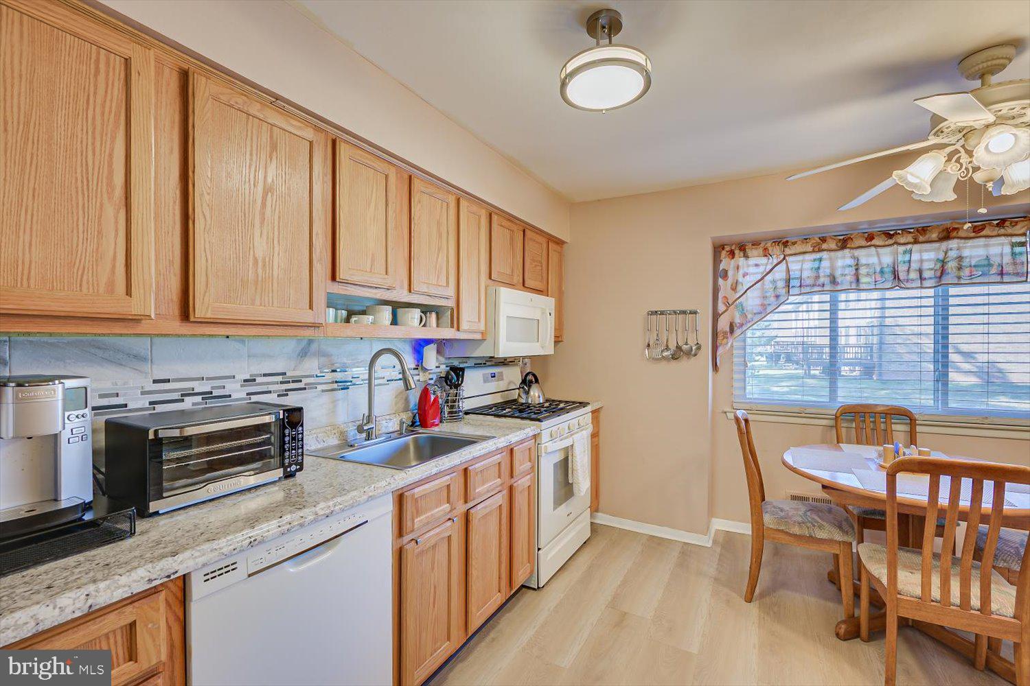 806 Robin Road Hillsborough, NJ 08844 - Photo 15 of 37 a kitchen with stainless steel appliances granite countertop a stove top oven a sink dishwasher and cabinets with wooden floor