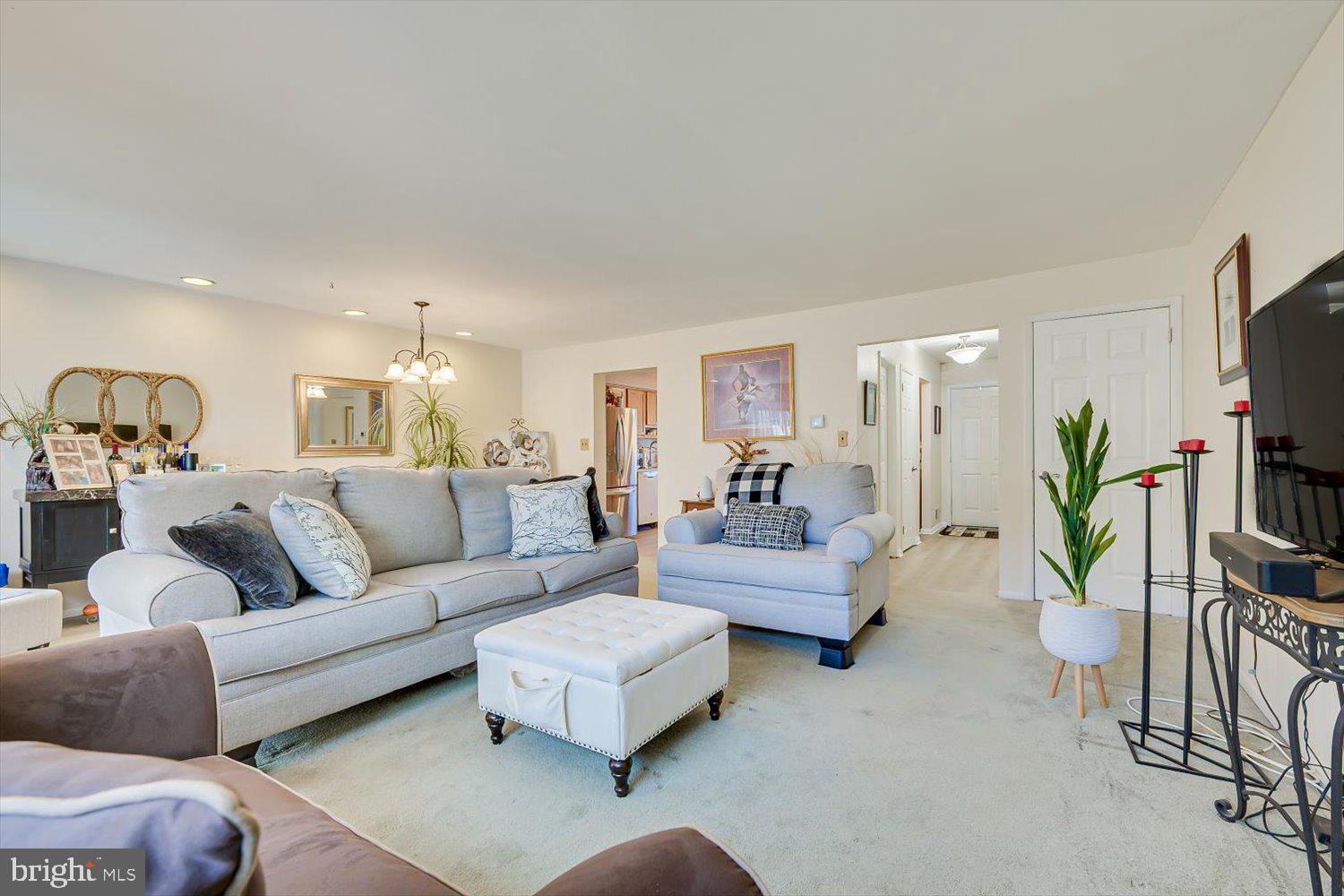 806 Robin Road Hillsborough, NJ 08844 - Photo 8 of 37 a living room with furniture and a flat screen tv