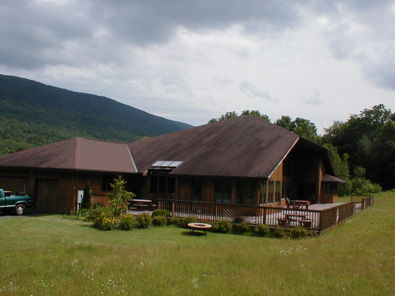 a view of a house with swimming pool and sitting area