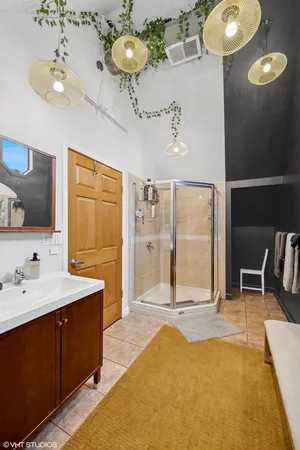 a spacious bathroom with a tub sink and mirror