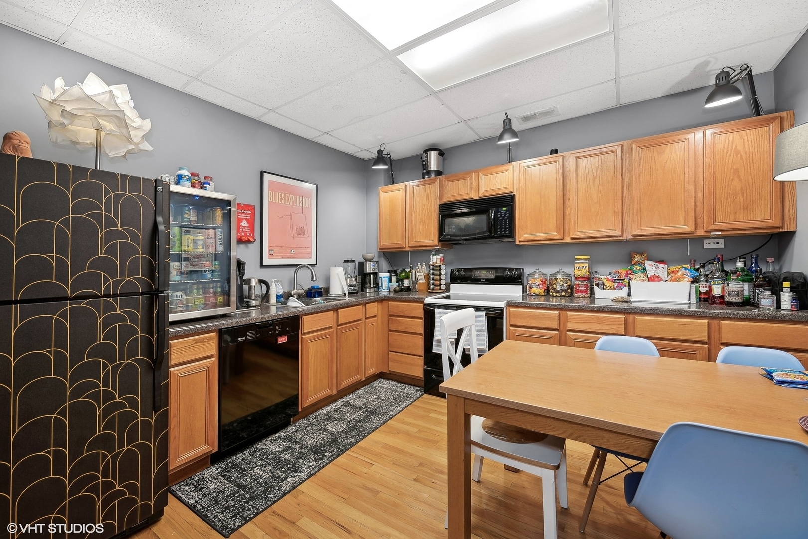 3522 West Armitage Avenue Chicago, IL 60647 - Photo 10 of 18 a kitchen with stainless steel appliances granite countertop a sink a stove a microwave a refrigerator cabinets and chairs
