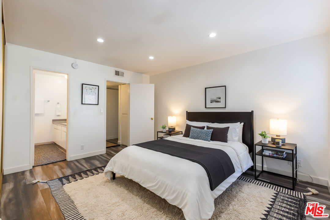 11701 Texas Avenue, Unit 306 Los Angeles, CA 90025 - Photo 28 of 42 a bedroom with a bed and a night stand