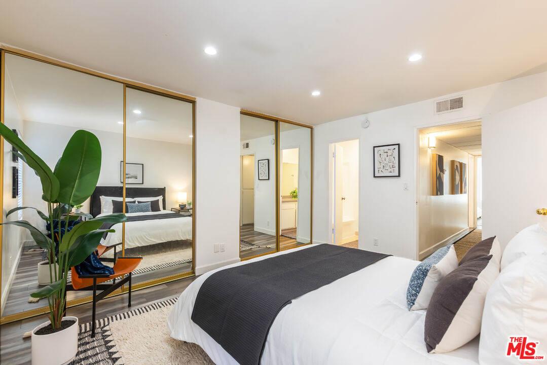 11701 Texas Avenue, Unit 306 Los Angeles, CA 90025 - Photo 29 of 42 a bedroom with a bed lamps and wooden floor