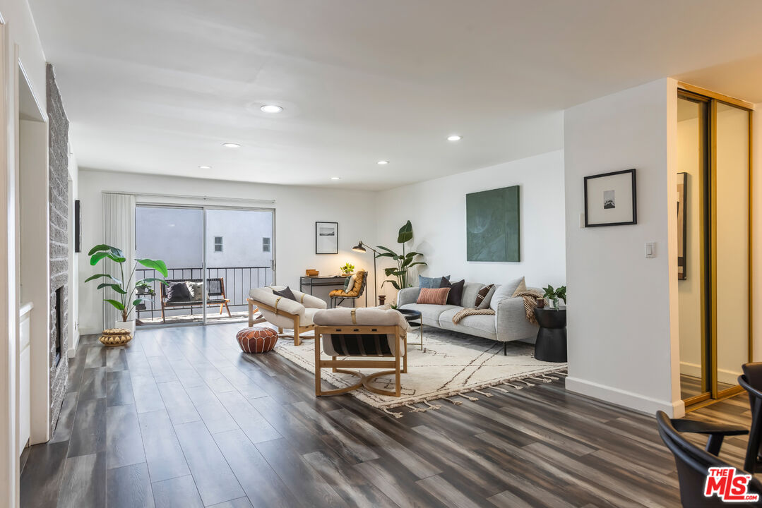 11701 Texas Avenue, Unit 306 Los Angeles, CA 90025 - Photo 6 of 42 a living room with furniture or wooden floor and a large window