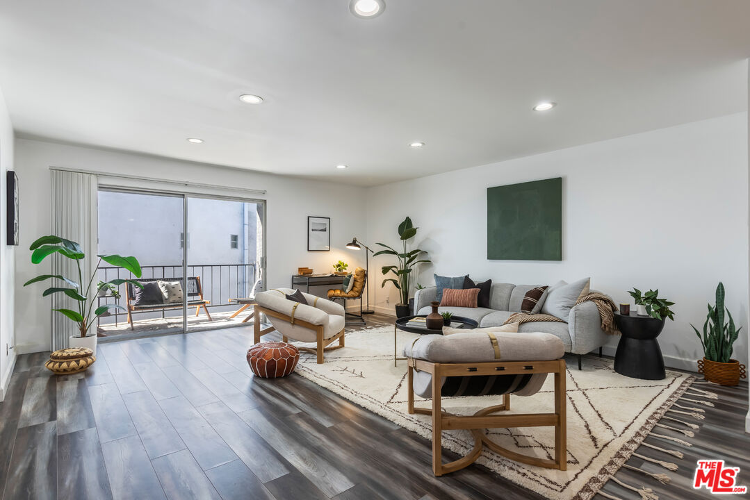 11701 Texas Avenue, Unit 306 Los Angeles, CA 90025 - Photo 7 of 42 a living room with furniture or wooden floor and a large window