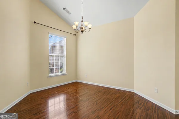 a view of a kitchen with a sink cabinets and wooden floor