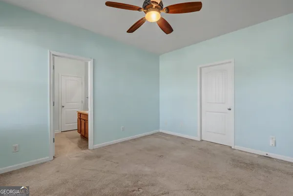 a view of room with window and ceiling fan