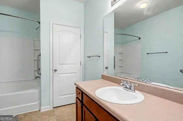 a bathroom with bathtub and shower