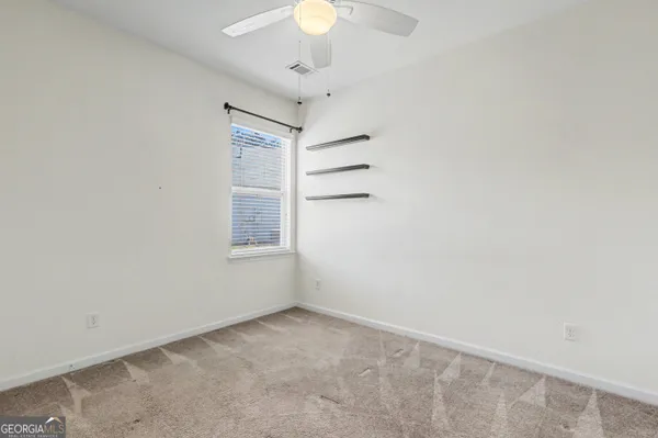 an empty room with a hallway and closet