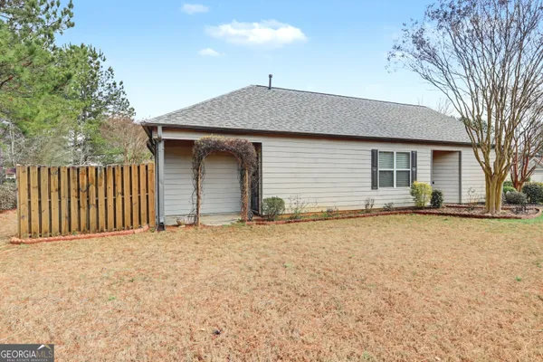 a view of a house with wooden fence