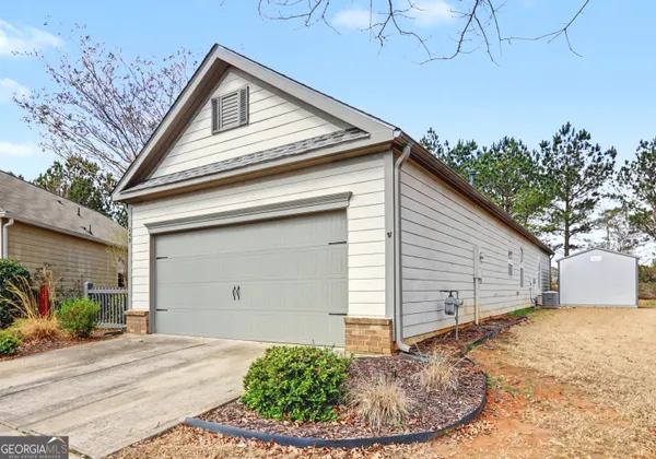 a view of a house with a wooden fence